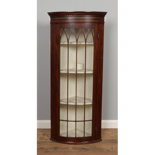 469 - A 19th century mahogany bow fronted wall hanging corner cabinet with inlaid design.

Hx127cm
Wx57cm