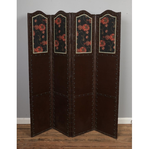 470 - A 20th century mahogany and leather upholstered four panelled folding screen with floral panels