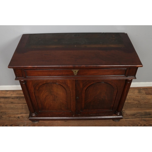 476 - A large mahogany bookcase base with two cupboard doors with columns to either side and singular draw... 