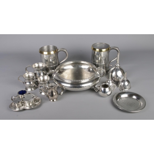 117 - A quantity of highly polished pewter including tankards, centerpiece bowl, cruet set etc.