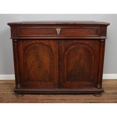 500 - A large mahogany bookcase base with two cupboard doors with columns to either side and singular draw... 