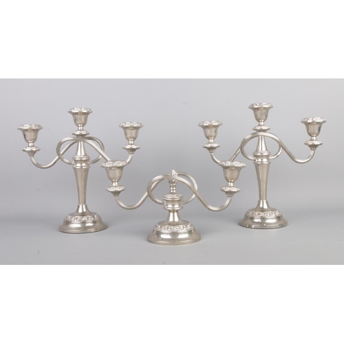 105 - A pair of silver plated three branch candelabra, together with a small two branch centerpiece with c... 