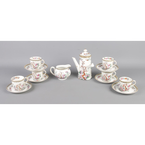 106 - A Royal Doulton Indian Tree six place miniature tea service. Includes pourer, cream jug and six cups... 