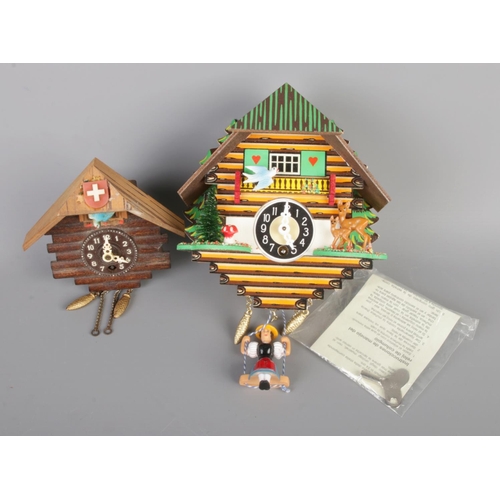 122 - Two decorative cuckoo clocks, both come with keys and one boxed with manual. Height 11cm and 15cm.