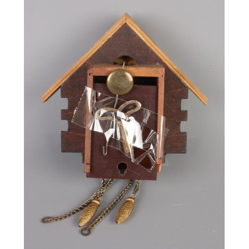 122 - Two decorative cuckoo clocks, both come with keys and one boxed with manual. Height 11cm and 15cm.