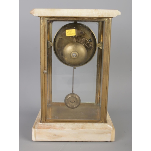 20 - An antique Alabaster mantel clock garniture, comprising a rectangular glass-cased clock, with a Arab... 