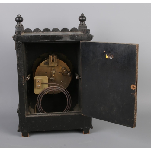 31 - An antique French Aesthetic movement mantel clock by Samuel Marti, featuring an ebonised case with t... 