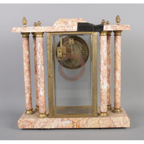 34 - An antique French marble pillared mantel clock by Bennet & Pottier, featuring an enamel dial with Ar... 