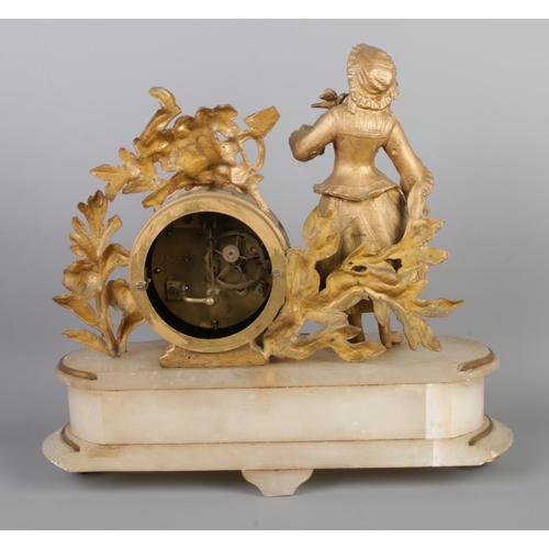 38 - An antique French gilt bronze figural mantel clock garniture, with two bronze candelabra. The clock ... 