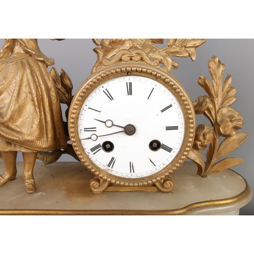 38 - An antique French gilt bronze figural mantel clock garniture, with two bronze candelabra. The clock ... 