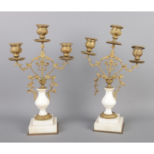 38 - An antique French gilt bronze figural mantel clock garniture, with two bronze candelabra. The clock ... 