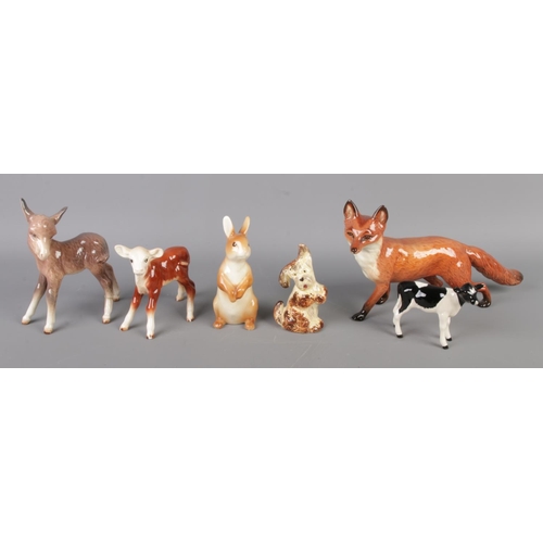 39 - A group of collectable porcelain figures, including five Royal Doulton figurines with Beswick animal... 