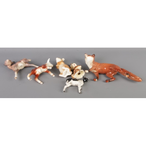 39 - A group of collectable porcelain figures, including five Royal Doulton figurines with Beswick animal... 