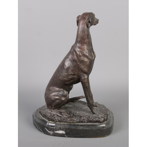 43 - After JM Barrie, a bronze model of a seated greyhound on marble base. Signed Barrie. Height 19.5cm.