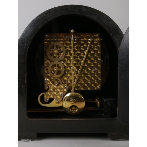 49 - A dome top Smiths Enfield mantle clock, with Roman Numeral dial and bearing presentation plaque to f... 