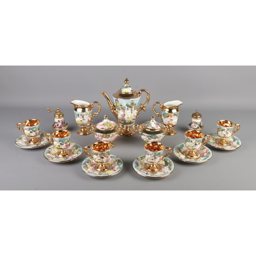 60 - A Capodimonte style tea service featuring gilt edging and decorated with cherubs. Comprising of cups... 