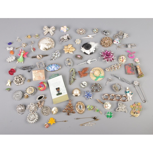 63 - A large collection of costume jewellery brooches, tie slides and scarf rings to include Stratton, fl... 