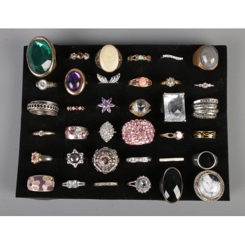 84 - A tray of assorted dress rings to include floral, signet and cluster examples.