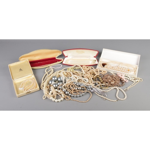 87 - A box of mixed faux pearls including bracelets and necklaces.