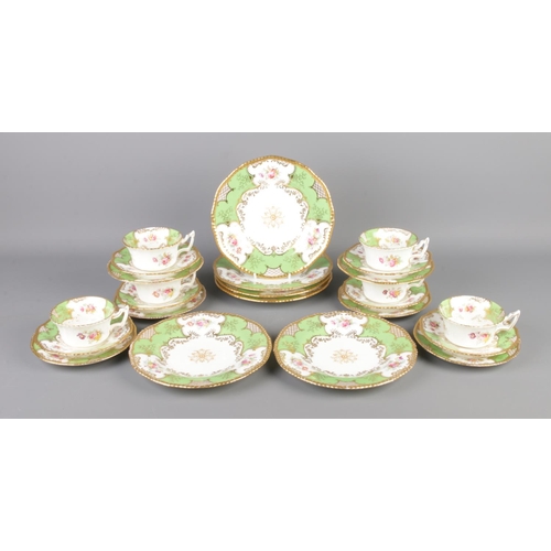 93 - A collection of Coalport ceramics in the green batwing design, consisting of cup, saucer and plate t... 