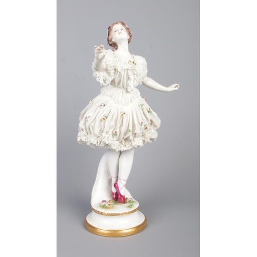 16 - An early 20th century German Volkstedt porcelain figure of a ballerina. With lacework dress encruste... 