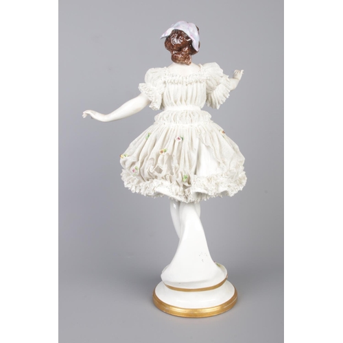 16 - An early 20th century German Volkstedt porcelain figure of a ballerina. With lacework dress encruste... 