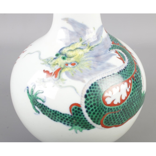 2 - A Chinese bottle vase decorated with a dragon in the famille verte design. Bearing six character mar... 