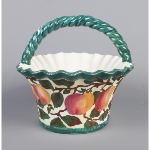 20 - A Robert Heron & Sons Wemyss Ware basket. Hand painted with apples. Height 21cm, Width 30cm.