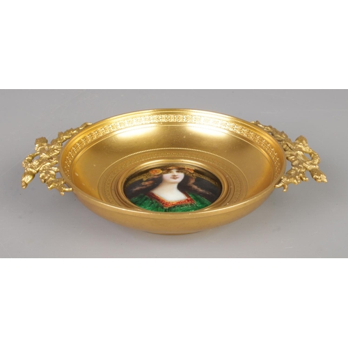 21 - A French gilt bronze twin handled dish. Having central enamelled plaque depicting a maiden, possibly... 