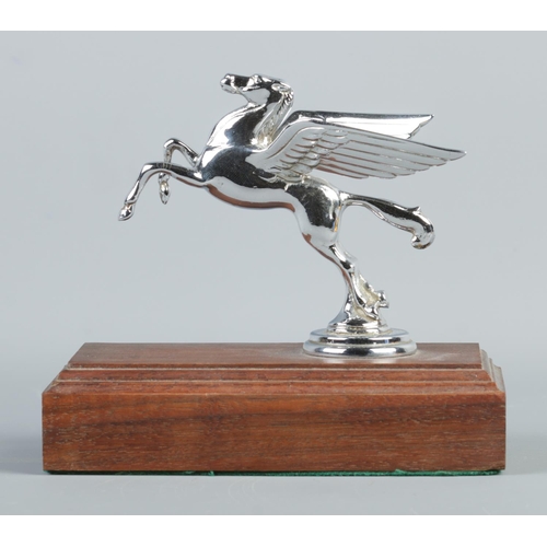 23 - A chrome plated Mobil Oil hood/car mascot in the form of a Pegasus. Raised on stepped mahogany base.... 