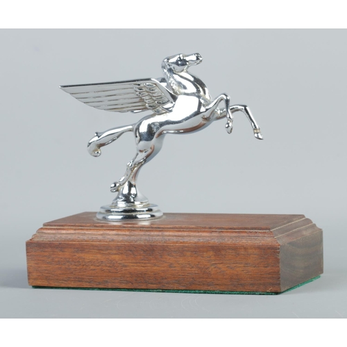 23 - A chrome plated Mobil Oil hood/car mascot in the form of a Pegasus. Raised on stepped mahogany base.... 