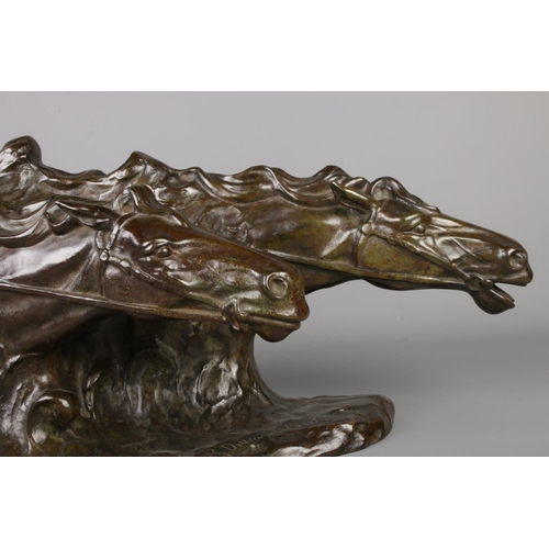 35 - A bronze sculpture modelled as two horses heads. Signed R De Wandeleir. Height 26cm, Length 50cm.