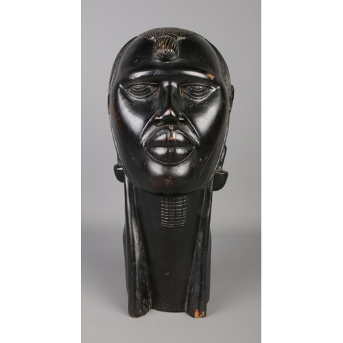 38 - A large African ebony bust of a tribeswoman. Height 39cm.