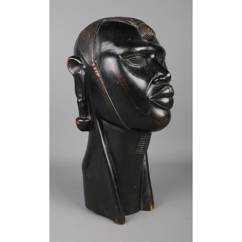 38 - A large African ebony bust of a tribeswoman. Height 39cm.