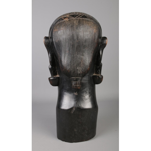 38 - A large African ebony bust of a tribeswoman. Height 39cm.