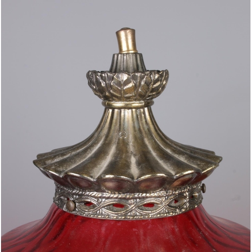 40 - A vintage brass lamp with large cranberry glass shade. Height 61cm.