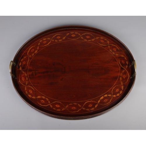 46 - A Victorian mahogany twin handled oval tray. With marquetry inlaid decoration. 49cm x 62cm.