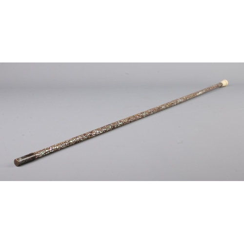 51 - A ladies abalone set walking cane with bone pommel and white metal mounts. Length 87cm.