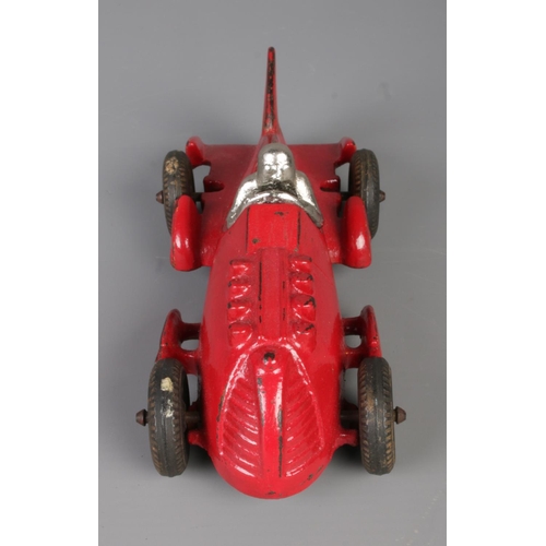 60 - A Hubley cast iron model racing car with driver. Length 17cm.