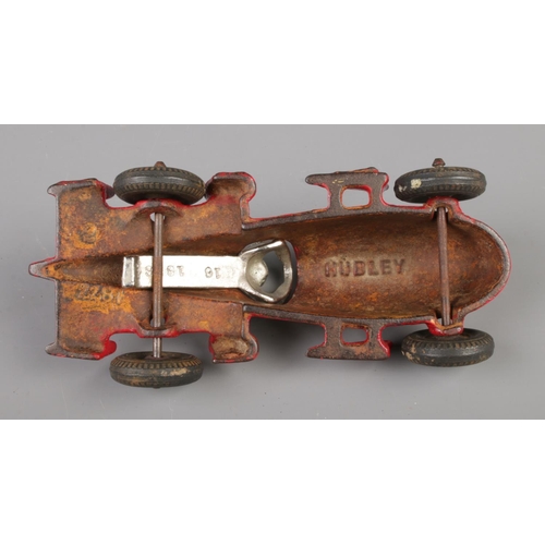 60 - A Hubley cast iron model racing car with driver. Length 17cm.