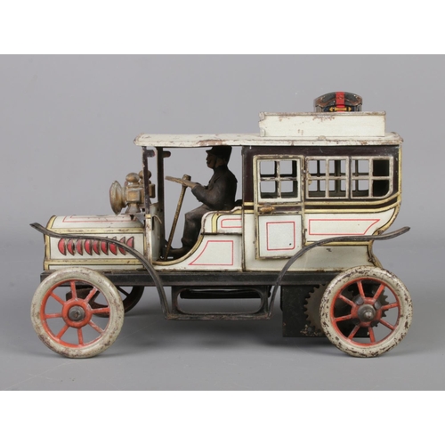 69 - A vintage German Gunthermann clockwork tin plate model limousine. With driver, original headlamps an... 