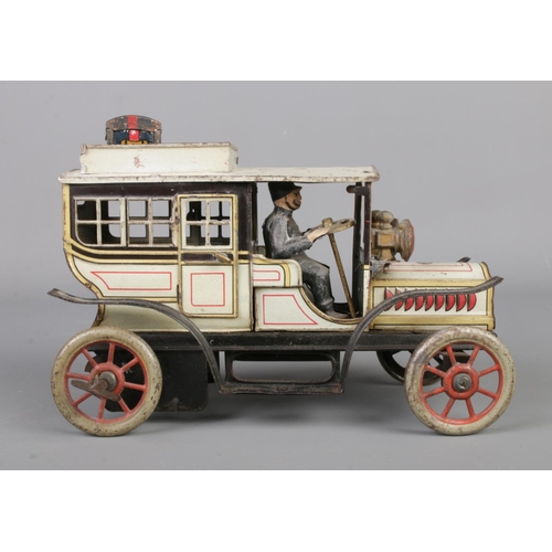 69 - A vintage German Gunthermann clockwork tin plate model limousine. With driver, original headlamps an... 