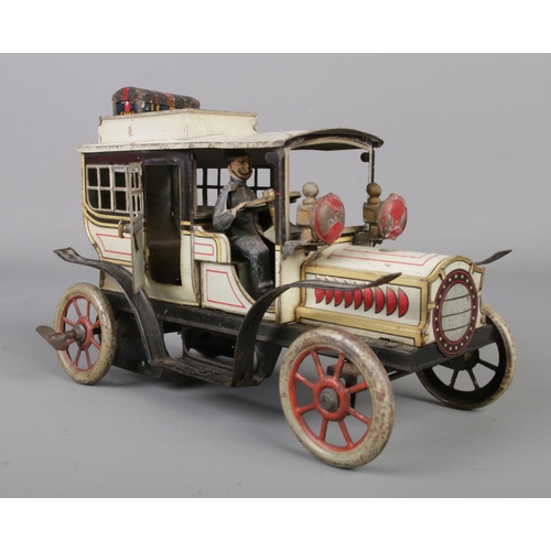 69 - A vintage German Gunthermann clockwork tin plate model limousine. With driver, original headlamps an... 