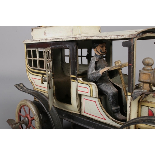 69 - A vintage German Gunthermann clockwork tin plate model limousine. With driver, original headlamps an... 