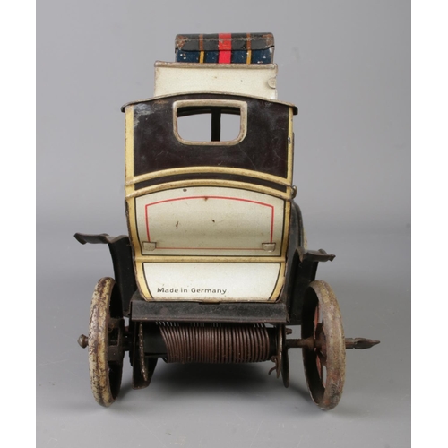 69 - A vintage German Gunthermann clockwork tin plate model limousine. With driver, original headlamps an... 