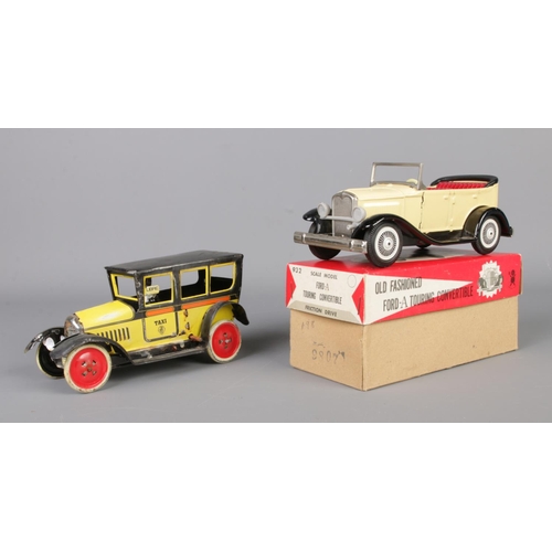 71 - A vintage Paya tin plate mechanical taxi along with a boxed Japanese tin plate Ford-A Touring Conver... 