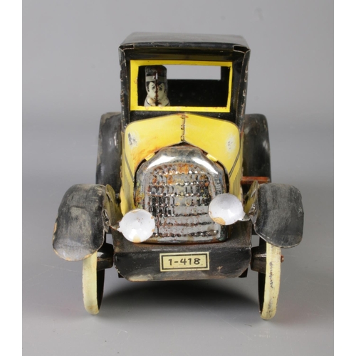 71 - A vintage Paya tin plate mechanical taxi along with a boxed Japanese tin plate Ford-A Touring Conver... 