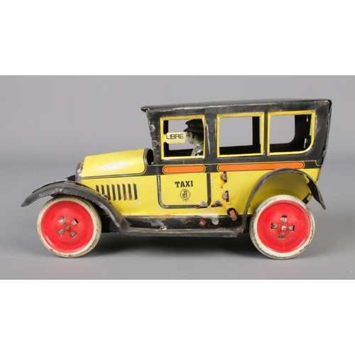 71 - A vintage Paya tin plate mechanical taxi along with a boxed Japanese tin plate Ford-A Touring Conver... 