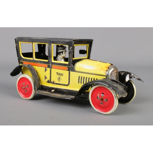 71 - A vintage Paya tin plate mechanical taxi along with a boxed Japanese tin plate Ford-A Touring Conver... 