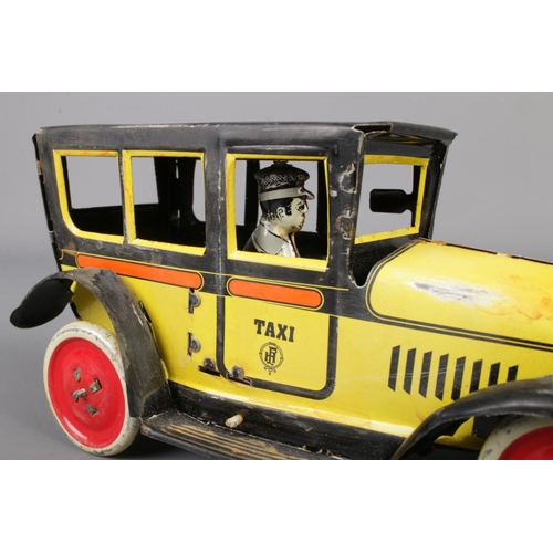 71 - A vintage Paya tin plate mechanical taxi along with a boxed Japanese tin plate Ford-A Touring Conver... 